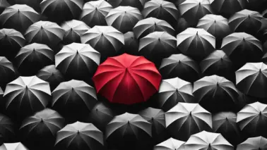 DALL·E 2024 05 26 12.10.43 A black and white depiction of a crowd of umbrellas seen from above. The umbrella in the center is bright red, standing out starkly against the monoch